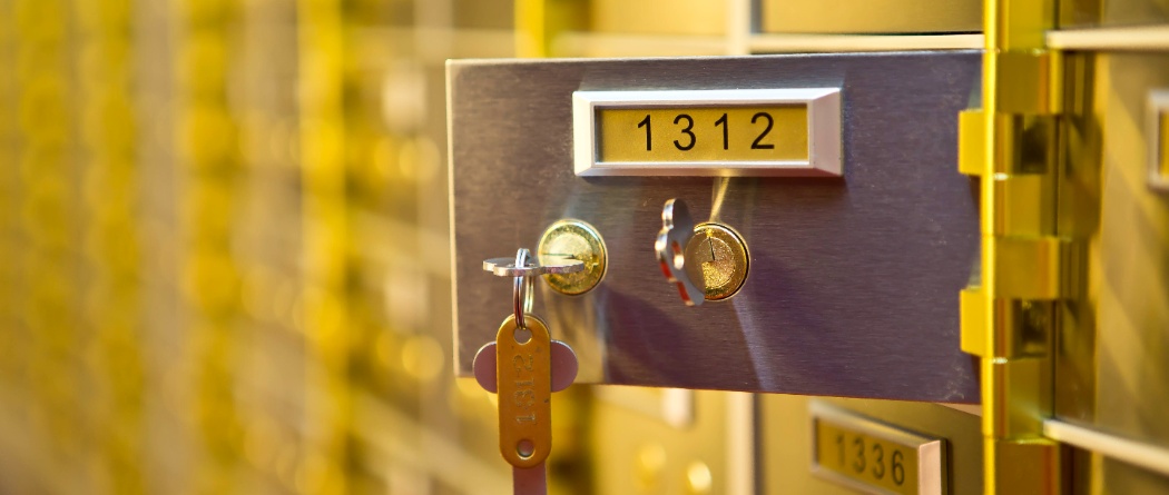a row of safe deposit boxes with keys in the lock