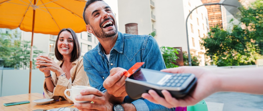 a man paying with his credit/debit card