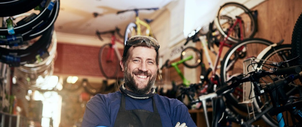 a bike shop owner standing in his shop